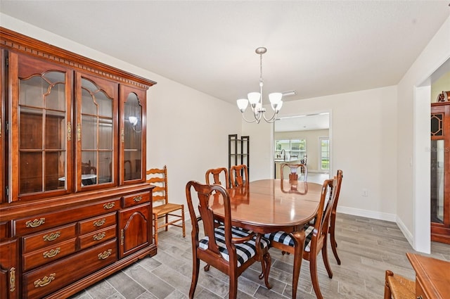 4610 Clarke St, North Port, FL 34286 - dining area featuring light wood-style flooring, a chandelier, and baseboards