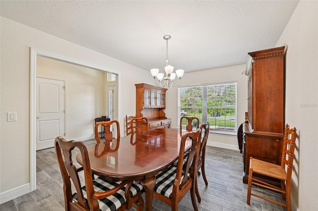 4610 Clarke St, North Port, FL 34286 - dining room with a chandelier, baseboards, and wood finished floors