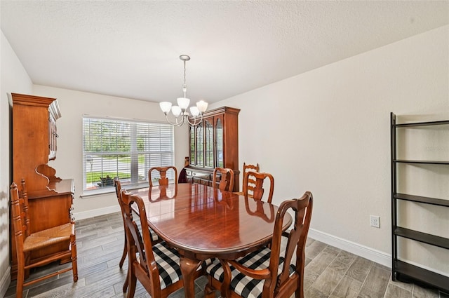 4610 Clarke St, North Port, FL 34286 - dining room with a chandelier, wood finished floors, and baseboards