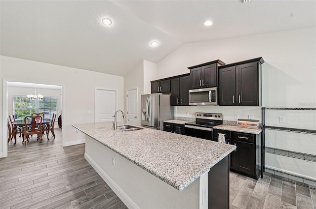 4610 Clarke St, North Port, FL 34286 - kitchen featuring appliances with stainless steel finishes, a sink, lofted ceiling, a center island with sink, and a chandelier