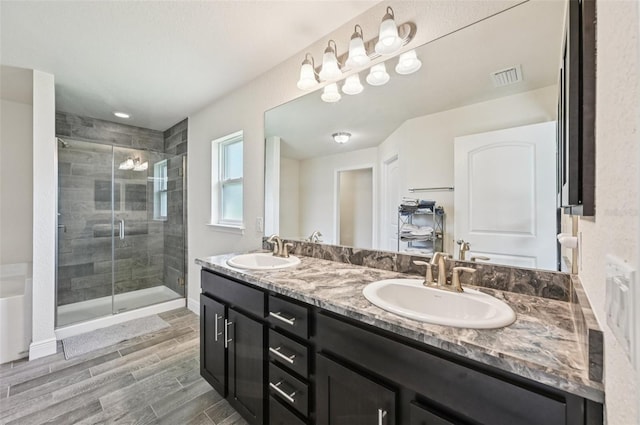 4610 Clarke St, North Port, FL 34286 - bathroom with double vanity, a stall shower, wood finish floors, and baseboards