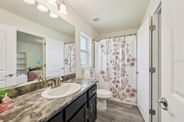 4610 Clarke St, North Port, FL 34286 - full bathroom with wood finished floors, vanity, toilet, a shower with curtain, and connected bathroom