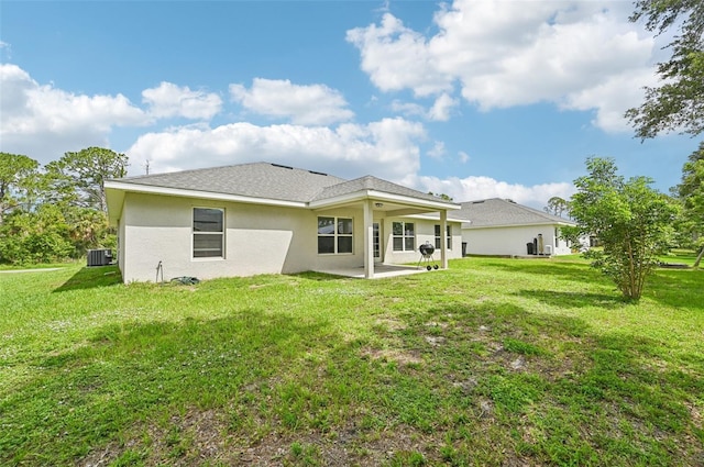 4610 Clarke St, North Port, FL 34286 - rear view of house featuring a patio, central AC, a yard, and stucco siding
