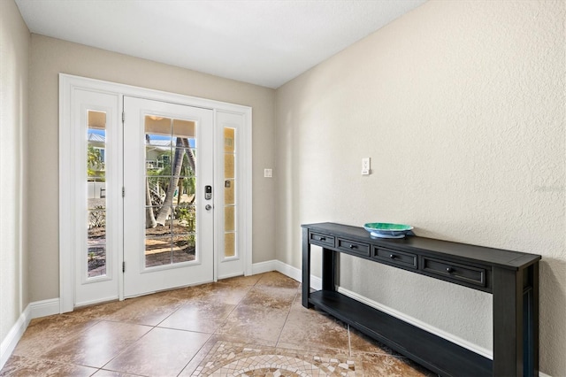 145 50th St, Holmes Beach, FL 34217 - tiled entryway featuring baseboards