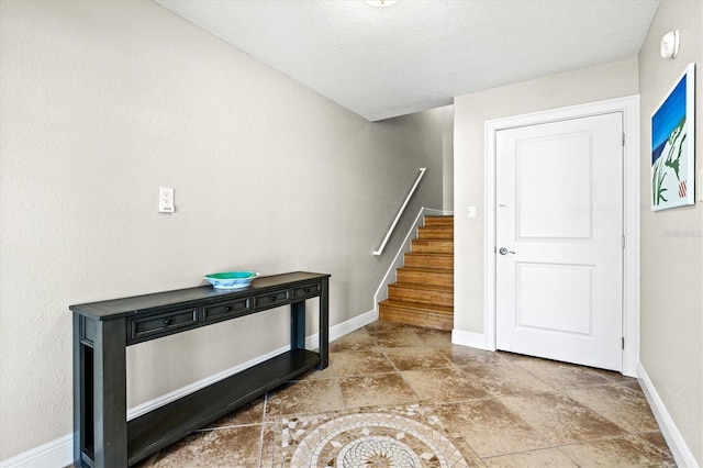 145 50th St, Holmes Beach, FL 34217 - entrance foyer with stairs and a textured ceiling