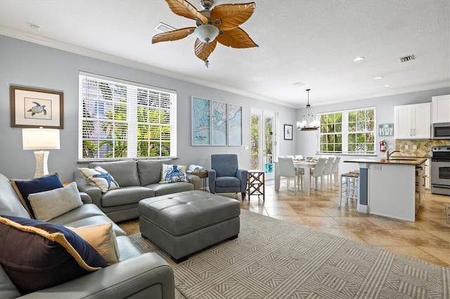 145 50th St, Holmes Beach, FL 34217 - living area featuring crown molding, a chandelier, a ceiling fan, light tile patterned floors, and recessed lighting