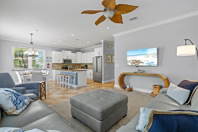 145 50th St, Holmes Beach, FL 34217 - living room featuring ornamental molding, a chandelier, a ceiling fan, light tile patterned floors, and recessed lighting