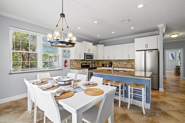 145 50th St, Holmes Beach, FL 34217 - dining area featuring crown molding, a chandelier, and recessed lighting