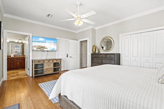 145 50th St, Holmes Beach, FL 34217 - bedroom with light wood-style flooring, ornamental molding, a closet, ceiling fan, and ensuite bathroom