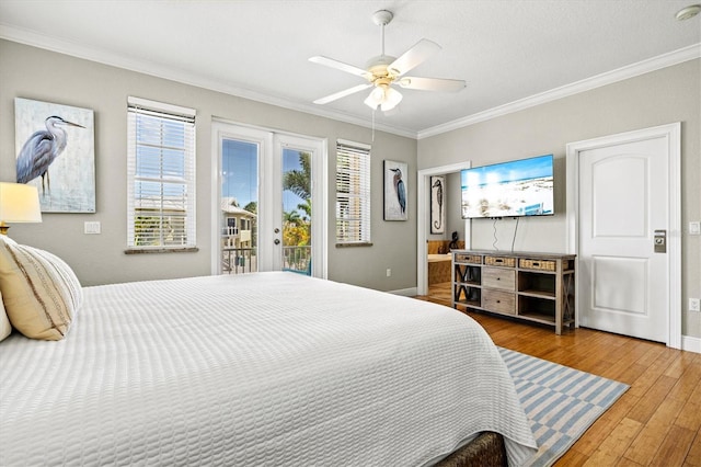 145 50th St, Holmes Beach, FL 34217 - bedroom featuring ornamental molding, access to exterior, hardwood / wood-style floors, and a ceiling fan