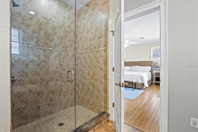 145 50th St, Holmes Beach, FL 34217 - ensuite bathroom featuring a shower stall, wood finished floors, ornamental molding, and a ceiling fan