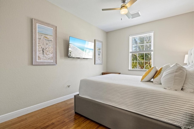 145 50th St, Holmes Beach, FL 34217 - bedroom with wood finished floors and ceiling fan