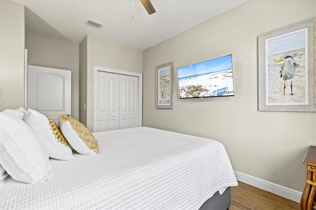 145 50th St, Holmes Beach, FL 34217 - bedroom with a closet, wood finished floors, and a ceiling fan