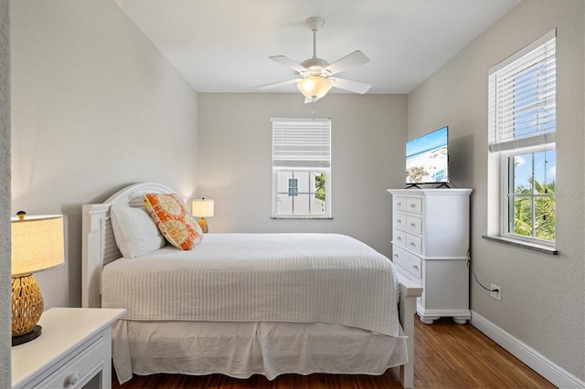 145 50th St, Holmes Beach, FL 34217 - bedroom with wood finished floors and a ceiling fan
