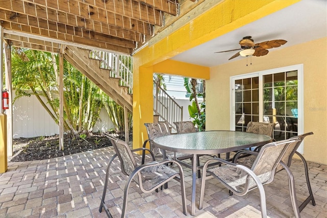 145 50th St, Holmes Beach, FL 34217 - view of patio featuring stairway, outdoor dining space, and ceiling fan