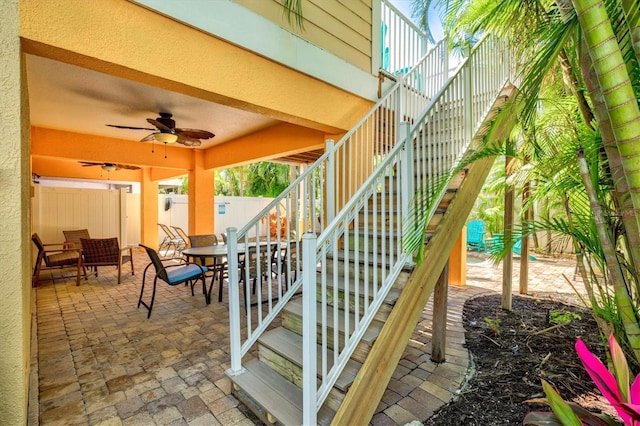 145 50th St, Holmes Beach, FL 34217 - fenced backyard with stairway, outdoor dining space, a patio area, and ceiling fan