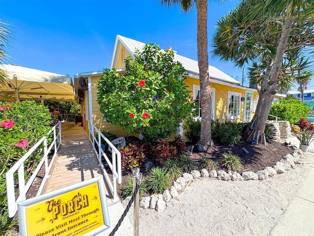 145 50th St, Holmes Beach, FL 34217 - view of front of property with a metal roof