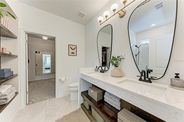3129 61st Ter E, Ellenton, FL 34222 - bathroom featuring double vanity, toilet, tiled shower, baseboards, and marble finish floors