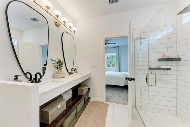 3129 61st Ter E, Ellenton, FL 34222 - ensuite bathroom with double vanity, tile patterned flooring, a shower stall, and baseboards