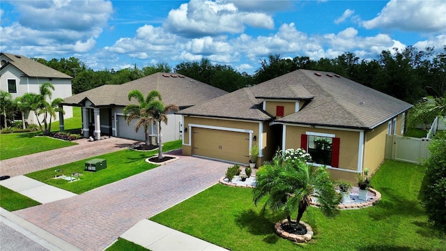3712 76th St E, Palmetto, FL 34221 - view of front of property with an attached garage, decorative driveway, stucco siding, and a shingled roof
