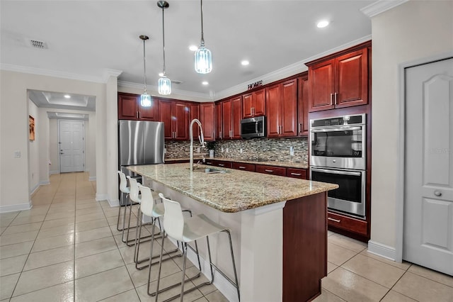 3712 76th St E, Palmetto, FL 34221 - kitchen with appliances with stainless steel finishes, reddish brown cabinets, a sink, backsplash, and ornamental molding