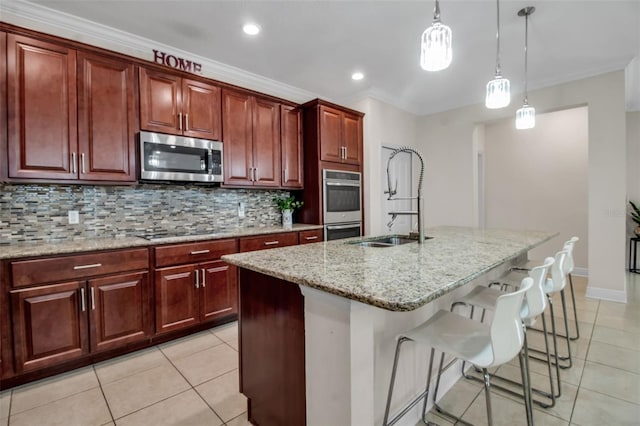 3712 76th St E, Palmetto, FL 34221 - kitchen with stainless steel appliances, a sink, light tile patterned floors, hanging light fixtures, and tasteful backsplash