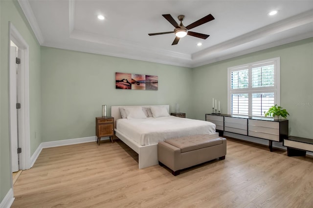 3712 76th St E, Palmetto, FL 34221 - bedroom featuring a tray ceiling, light wood-type flooring, crown molding, recessed lighting, and baseboards