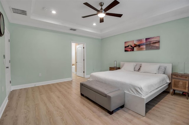 3712 76th St E, Palmetto, FL 34221 - bedroom with a tray ceiling, light wood-type flooring, recessed lighting, ornamental molding, and baseboards