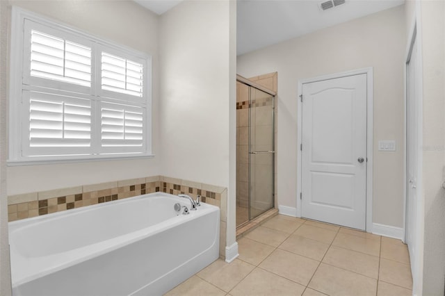 3712 76th St E, Palmetto, FL 34221 - bathroom with a shower stall, healthy amount of natural light, a bath, and tile patterned flooring