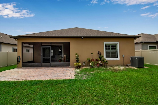 3712 76th St E, Palmetto, FL 34221 - rear view of property featuring a sunroom, central AC unit, stucco siding, and a patio