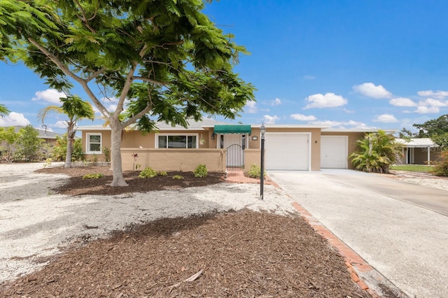715 Fontana Ln, Bradenton, FL 34209 - ranch-style home featuring stucco siding, a garage, concrete driveway, and a gate
