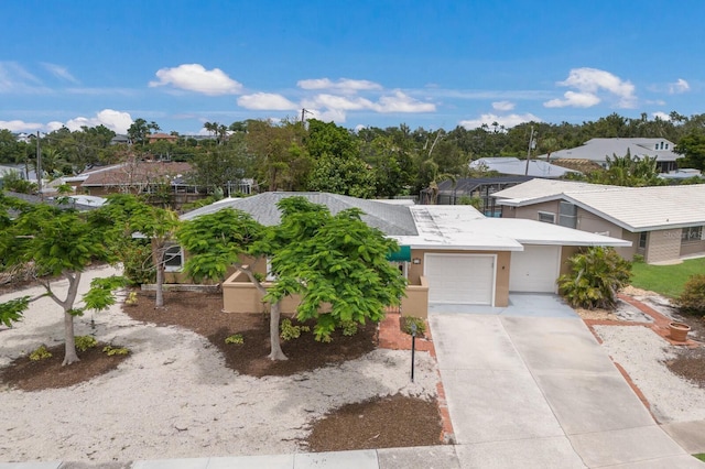 715 Fontana Ln, Bradenton, FL 34209 - view of front of home featuring a garage, driveway, and stucco siding