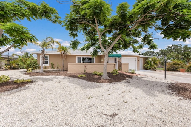 715 Fontana Ln, Bradenton, FL 34209 - ranch-style home with stucco siding, concrete driveway, and an attached garage