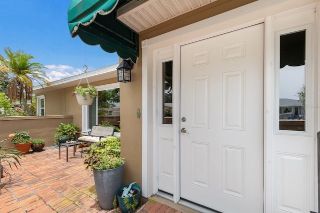 715 Fontana Ln, Bradenton, FL 34209 - property entrance with stucco siding and a patio