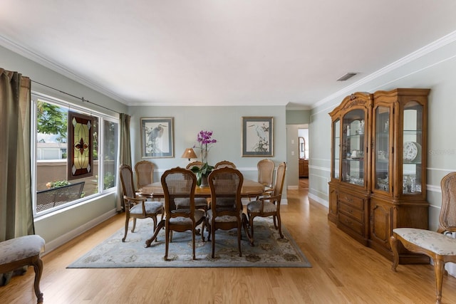 715 Fontana Ln, Bradenton, FL 34209 - dining area with light wood-style floors, crown molding, and baseboards