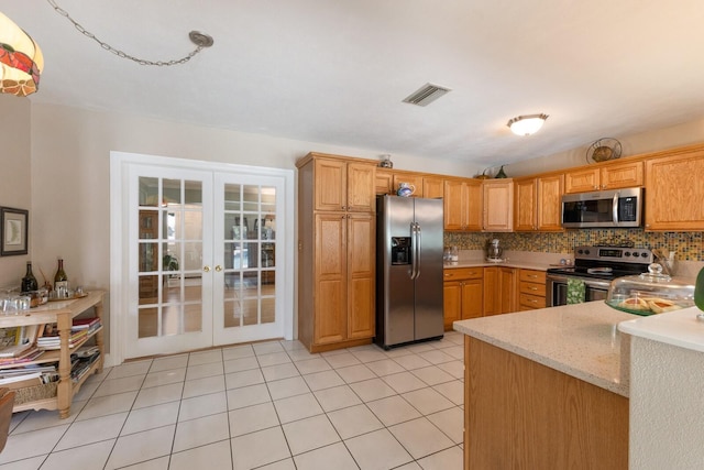 715 Fontana Ln, Bradenton, FL 34209 - kitchen featuring stainless steel appliances, french doors, tasteful backsplash, light stone counters, and light tile patterned flooring