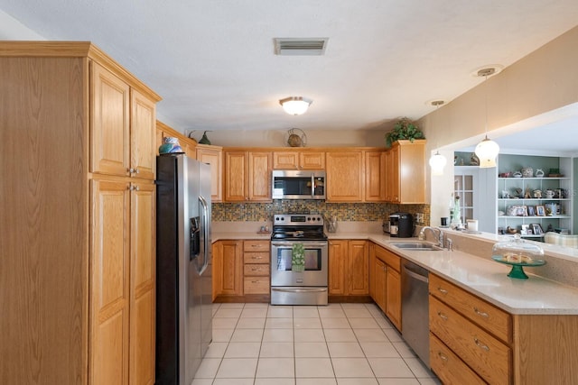 715 Fontana Ln, Bradenton, FL 34209 - kitchen with appliances with stainless steel finishes, a sink, light countertops, and backsplash