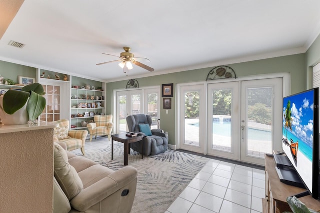715 Fontana Ln, Bradenton, FL 34209 - living area featuring light tile patterned floors, a ceiling fan, ornamental molding, french doors, and built in features