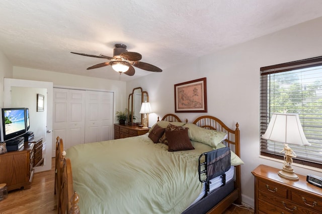 715 Fontana Ln, Bradenton, FL 34209 - bedroom with wood finished floors, a closet, a ceiling fan, and a textured ceiling