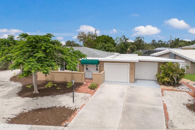 715 Fontana Ln, Bradenton, FL 34209 - view of front of home featuring an attached garage, stucco siding, a gate, and concrete driveway