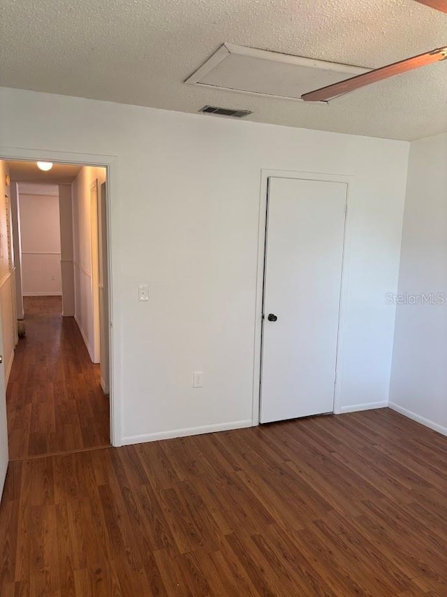 10800 N US Highway 19 Unit 237, Pinellas Park, FL 33782 - unfurnished bedroom with wood finished floors, baseboards, and a textured ceiling
