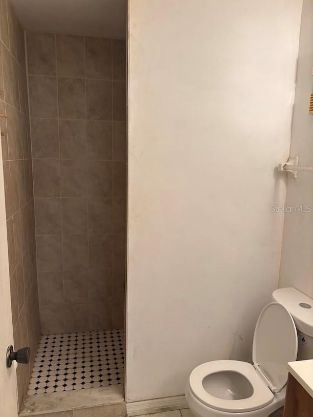 10800 N US Highway 19 Unit 237, Pinellas Park, FL 33782 - full bathroom with a stall shower, toilet, vanity, and tile patterned flooring