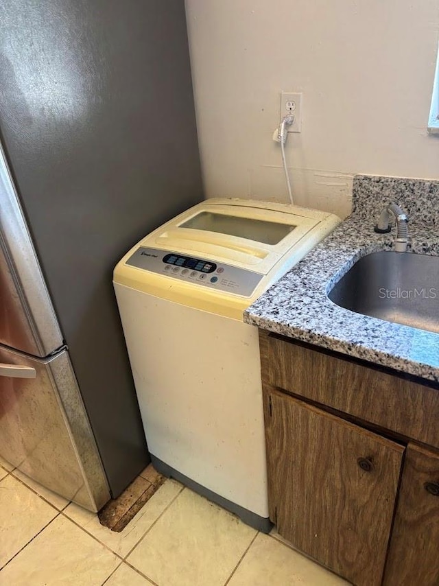 10800 N US Highway 19 Unit 237, Pinellas Park, FL 33782 - detailed view of washer / clothes dryer, a sink, and light stone counters