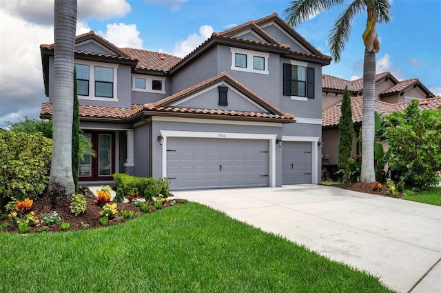 7020 Island Queen Ct, Sarasota, FL 34233 - mediterranean / spanish-style home with stucco siding, driveway, a tile roof, a front lawn, and a garage