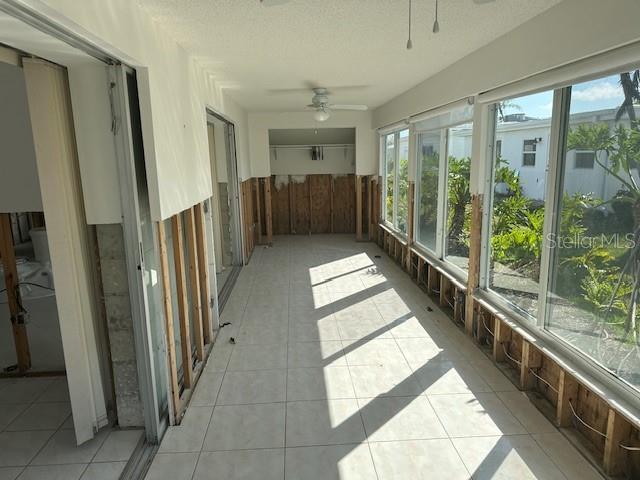 683 Spanish Dr S, Longboat Key, FL 34228 - unfurnished sunroom featuring tile patterned flooring