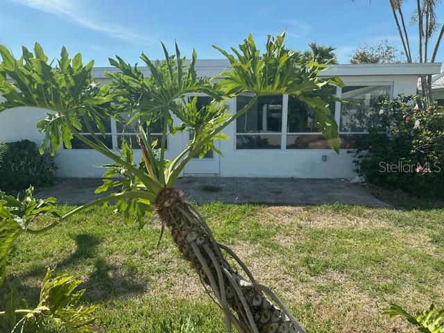 683 Spanish Dr S, Longboat Key, FL 34228 - view of green lawn featuring a sunroom