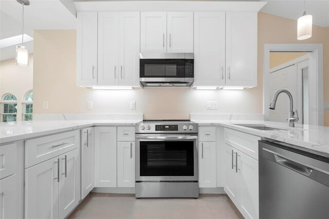 4472 Calle Serena, Sarasota, FL 34238 - kitchen featuring appliances with stainless steel finishes, a sink, white cabinets, a peninsula, and light stone counters