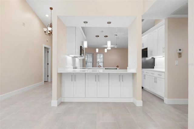 4472 Calle Serena, Sarasota, FL 34238 - kitchen featuring light countertops, ceiling fan, a peninsula, and white cabinets