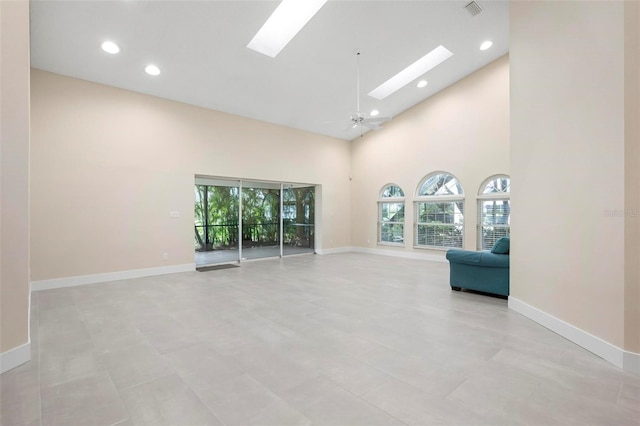 4472 Calle Serena, Sarasota, FL 34238 - unfurnished room with plenty of natural light, a skylight, baseboards, high vaulted ceiling, and recessed lighting