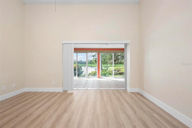4472 Calle Serena, Sarasota, FL 34238 - spare room with wood finished floors, baseboards, and a water view